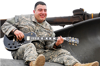 Nichola Raia playing a guitar