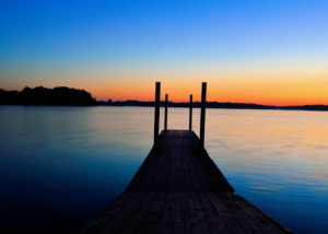 August 7, 2016 image of sun rising over a small dock extending into the water