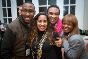 Four people smiling