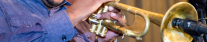 Man playing instrument to microphone