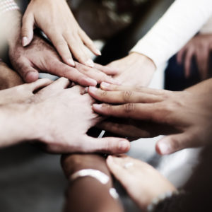 Photo of hands joining together